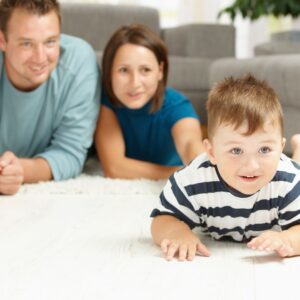 baby on floor with parents